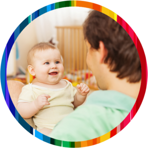 smiling baby on lap_rainbow circle 1024x1024