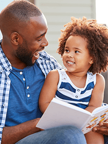dad reading to girl_216x288