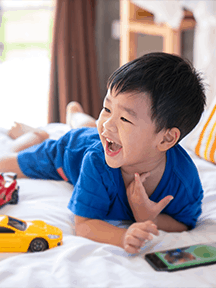 boy on bed playing_216x288