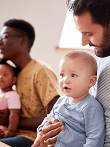 dads babies on laps_216x288 Photo of a child in a box illustrating ...