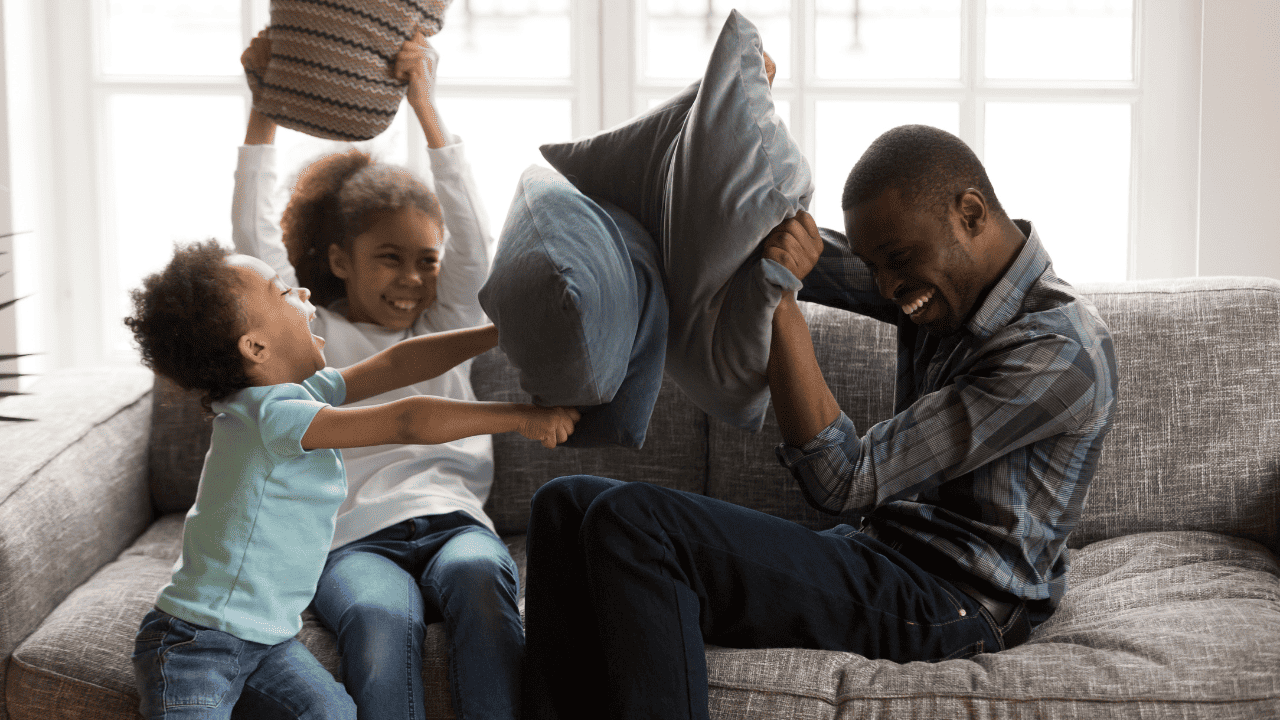 Family playing with pillows