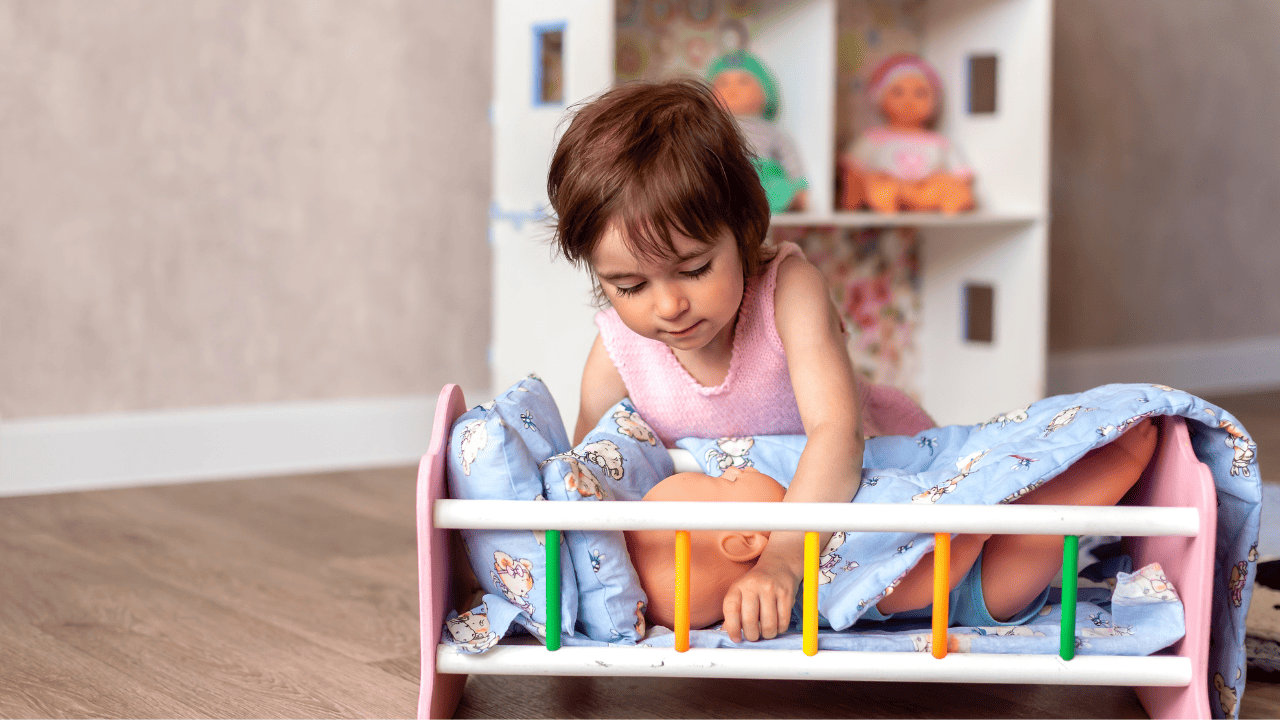 Child playing with baby doll